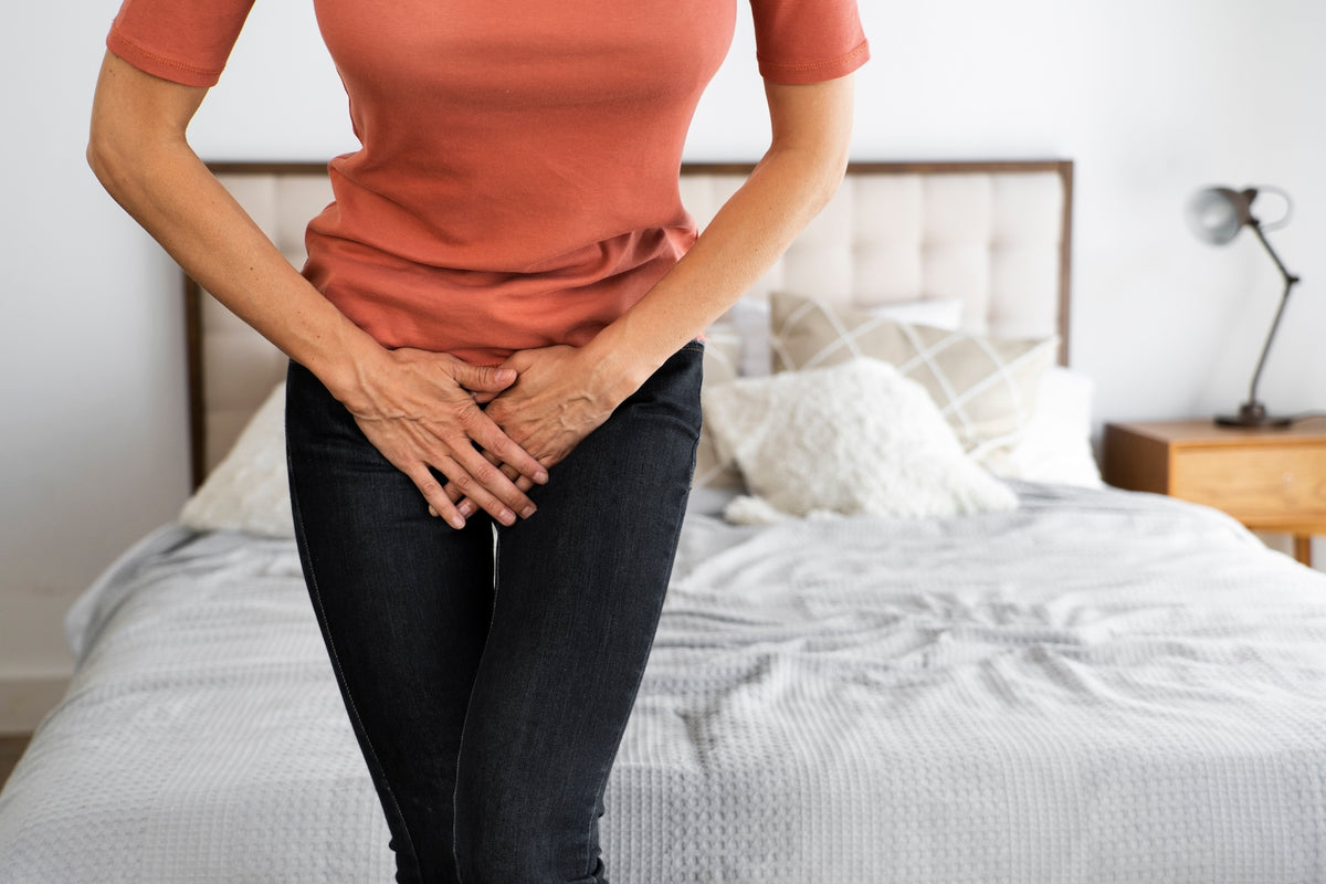 Woman indicating UTI discomfort for telehealth consultation
